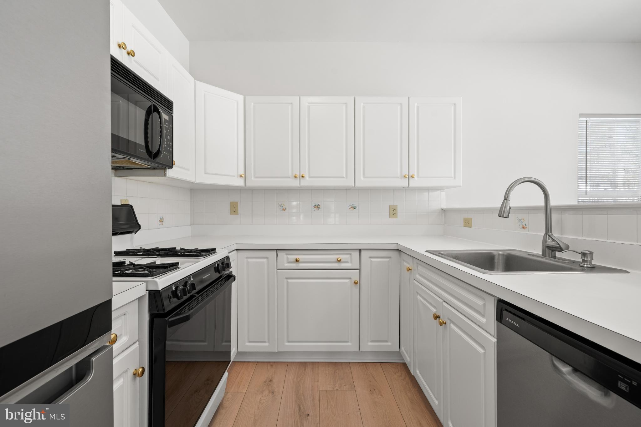 16 Newport Road Manahawkin, NJ 08050 - Photo 5 of 29 Modern kitchen with sleek white cabinetry.