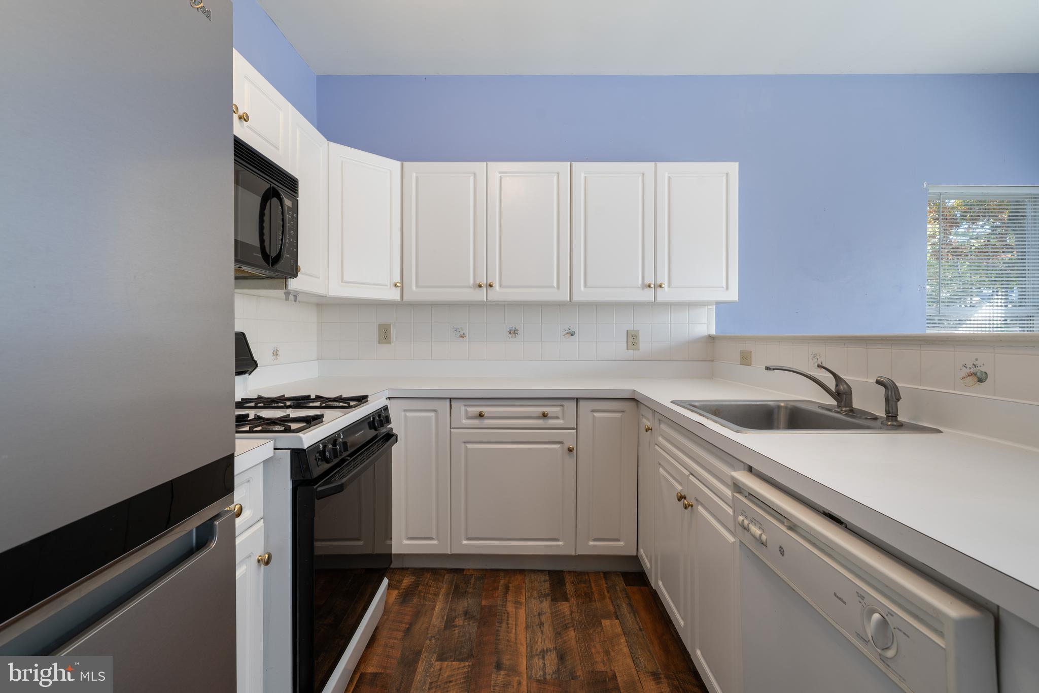 16 Newport Road Manahawkin, NJ 08050 - Photo 6 of 36 a kitchen with granite countertop a sink stove and cabinets