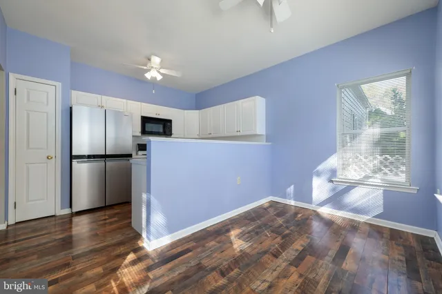 a view of an empty room with a fireplace and a window