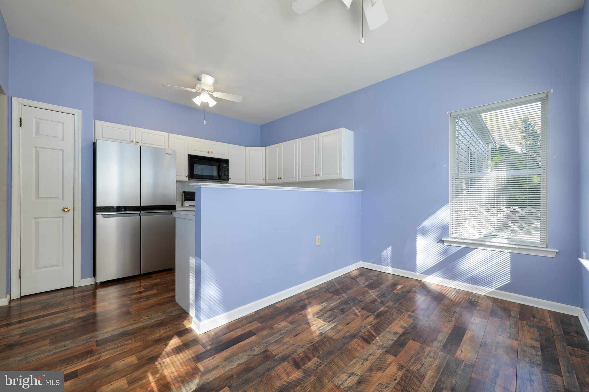 16 Newport Road Manahawkin, NJ 08050 - Photo 9 of 36 a view of empty room with wooden floor and kitchen view