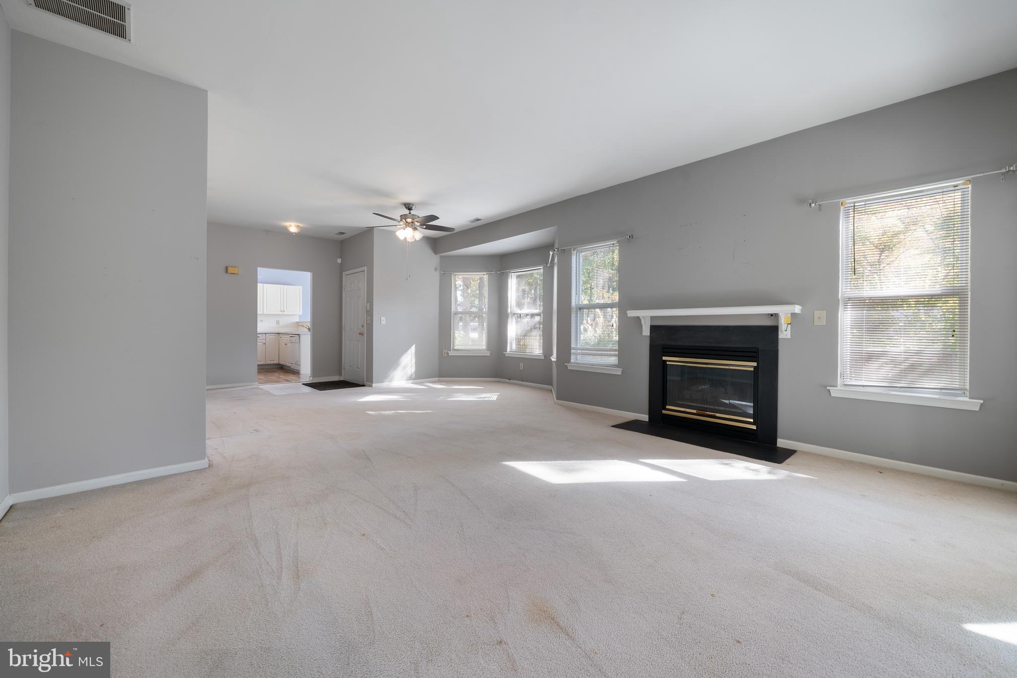 16 Newport Road Manahawkin, NJ 08050 - Photo 10 of 36 a view of an empty room with a fireplace and a window
