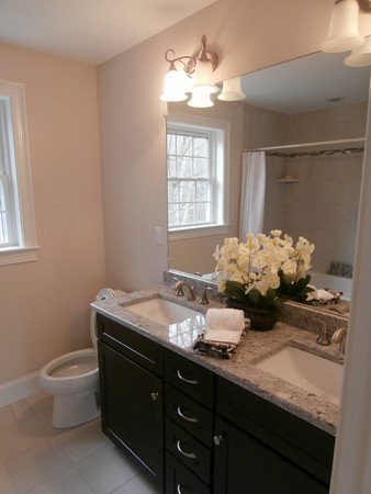 81 Bellevue Road Andover, MA 01810 - Photo 4 of 11 a bathroom with a granite countertop sink a large mirror and a toilet