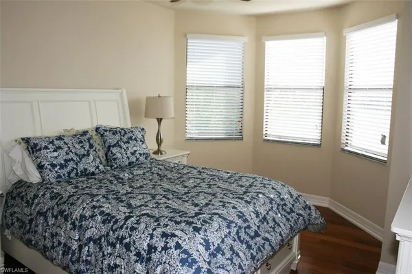 a bed sitting in a bedroom next to a window