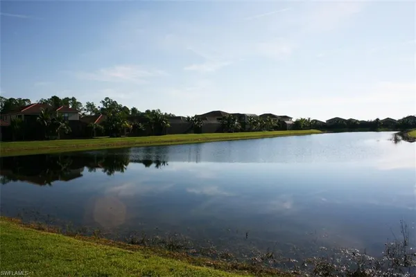 a view of a lake with houses in background