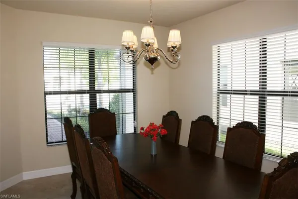a view of a dining room with furniture and window