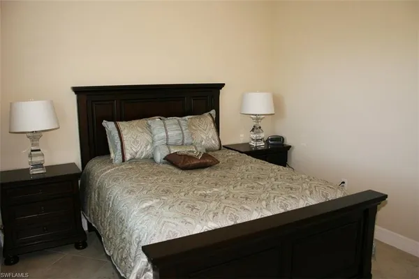 a bedroom with a bed and a lamp