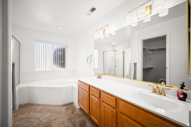 1825 West Mathis Park Place, Unit 46 St. George, UT 84770 - Photo 25 of 45 Full bathroom with a walk in closet, double vanity, dark carpet, a garden tub, and a shower stall
