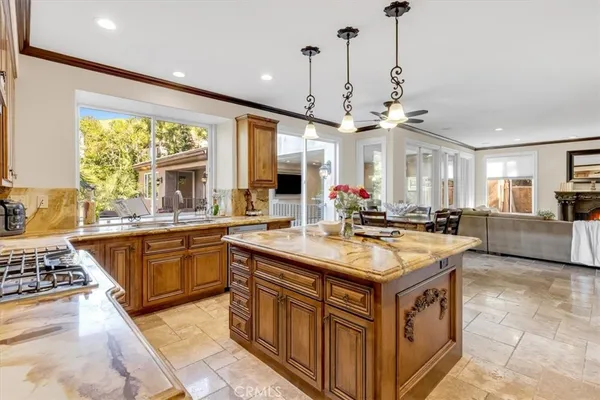 a kitchen with stainless steel appliances granite countertop a sink a stove and refrigerator