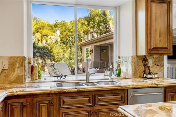 a bathroom with a granite countertop sink a mirror and a shower
