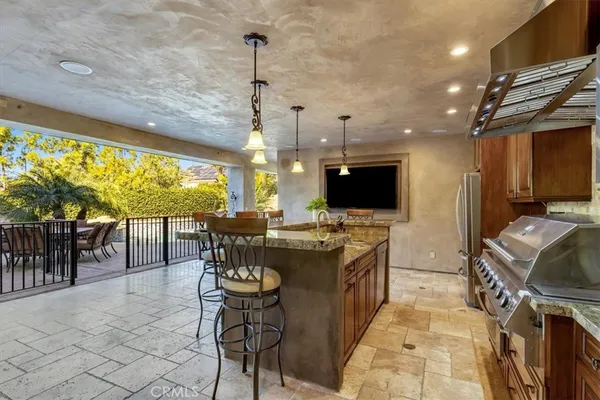 a spacious bathroom with a granite countertop sink a large mirror and a bathtub next to a window