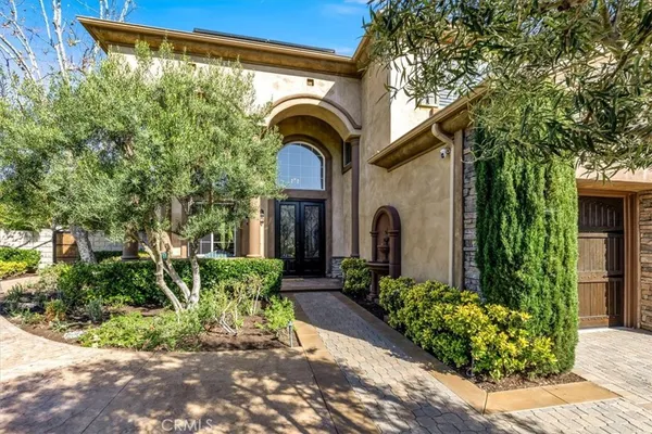 a view of staircase with lots of frames on wall and windows