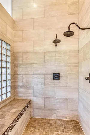 a bathroom with a granite countertop sink a toilet a mirror and shower
