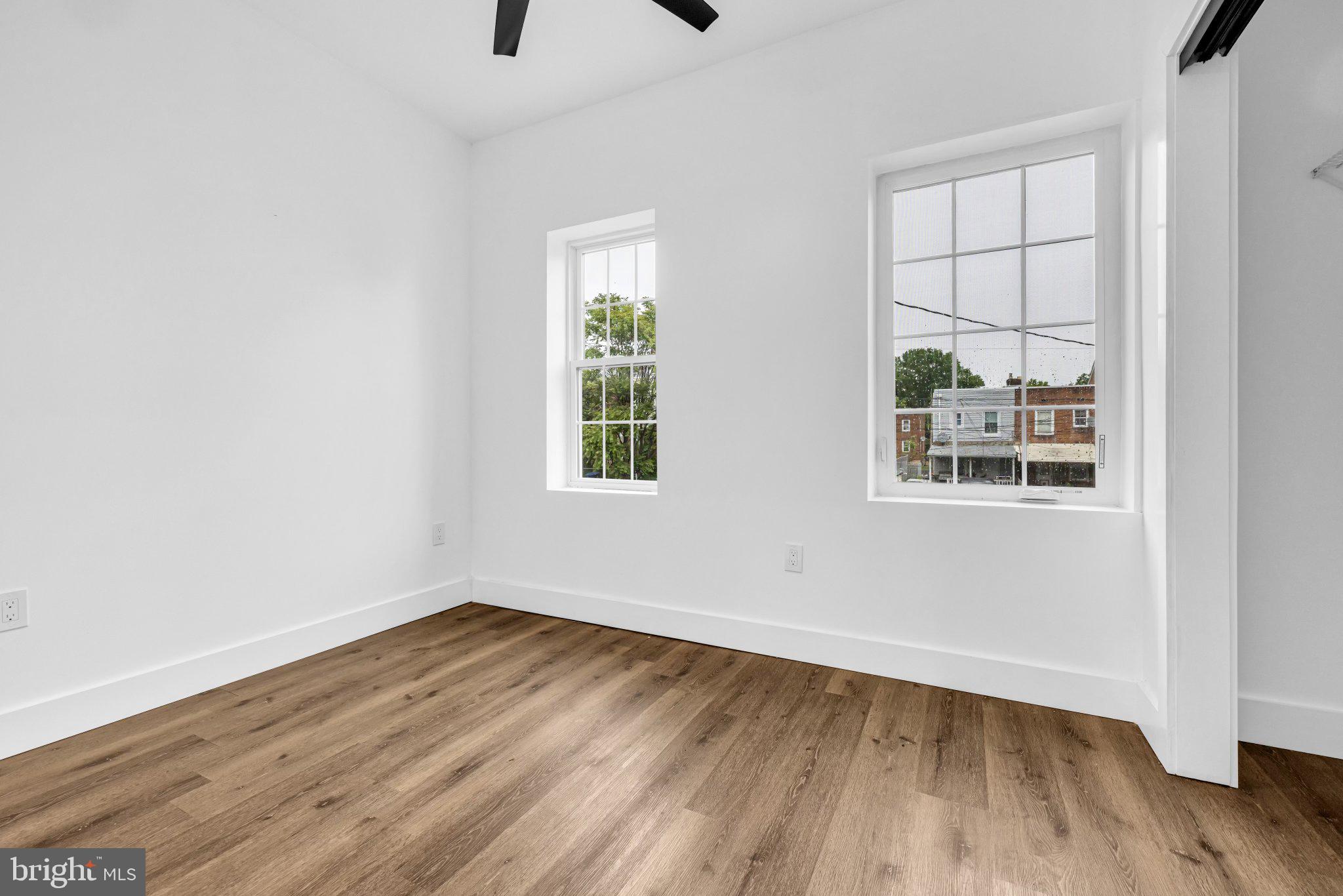 2801 Round Road Baltimore, MD 21225 - Photo 18 of 29 an empty room with wooden floor and windows