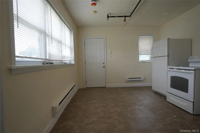 a view of a livingroom with furniture and a window