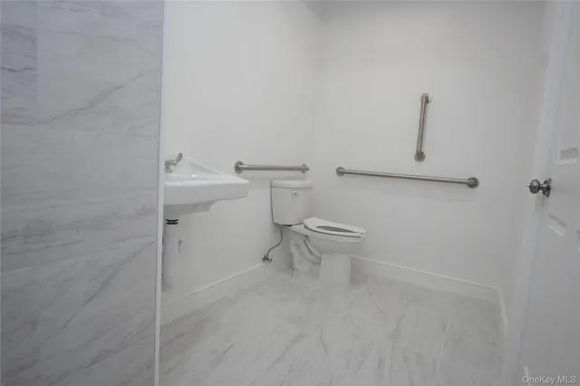 a bathroom with a toilet and a sink