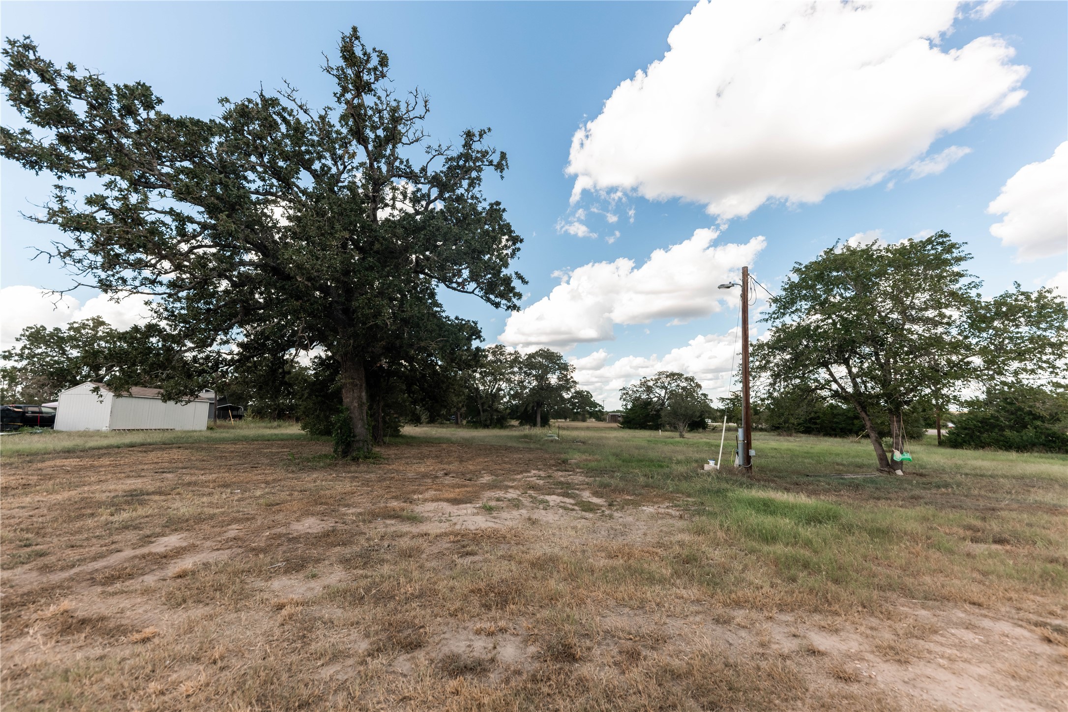 113 Hannah Road, Unit A Smithville, TX 78957 - Photo 7 of 11 a view of dirt field with trees