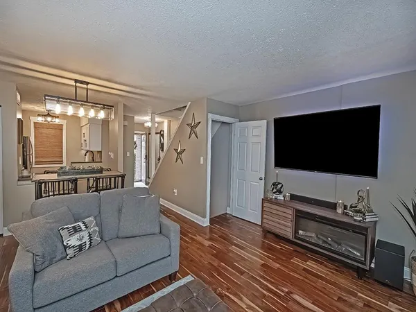 a living room with furniture and wooden floor