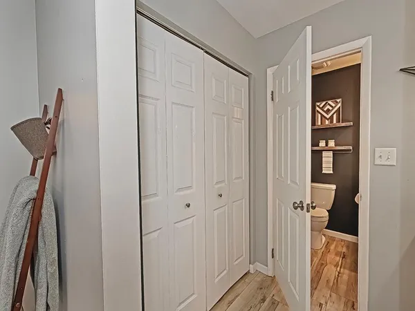 a bathroom with a toilet a sink and mirror