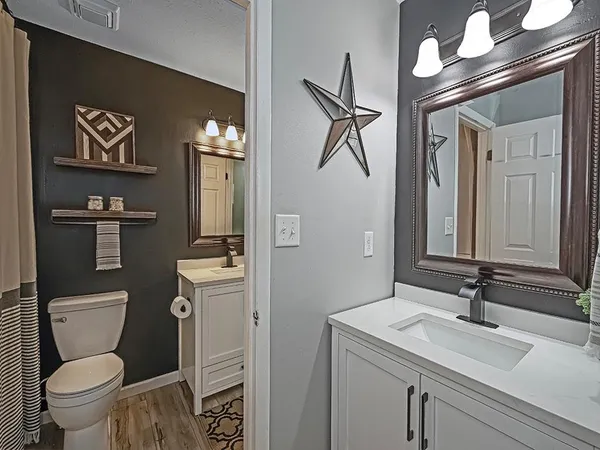 a bathroom with a sink toilet and shower