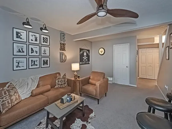 a living room with furniture a fireplace and a flat screen tv
