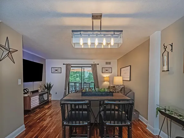 a view of a dining room with furniture window and wooden floor