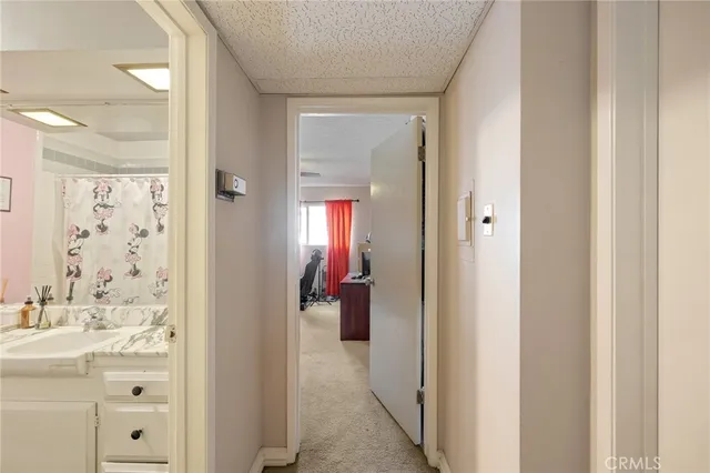 a bathroom with a sink and mirror with toilet