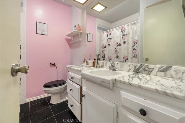 a bedroom with bed and a chandelier