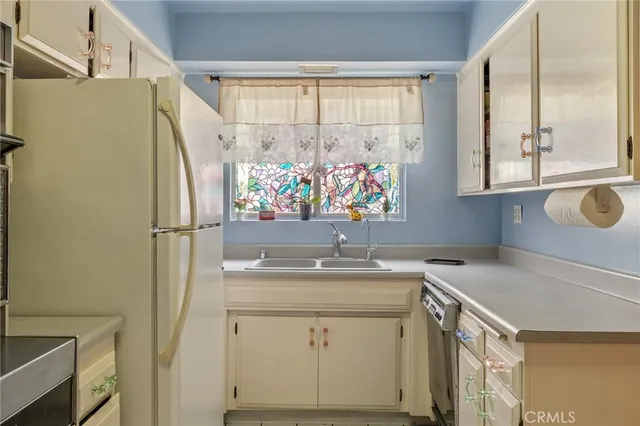 a kitchen with stainless steel appliances and cabinets
