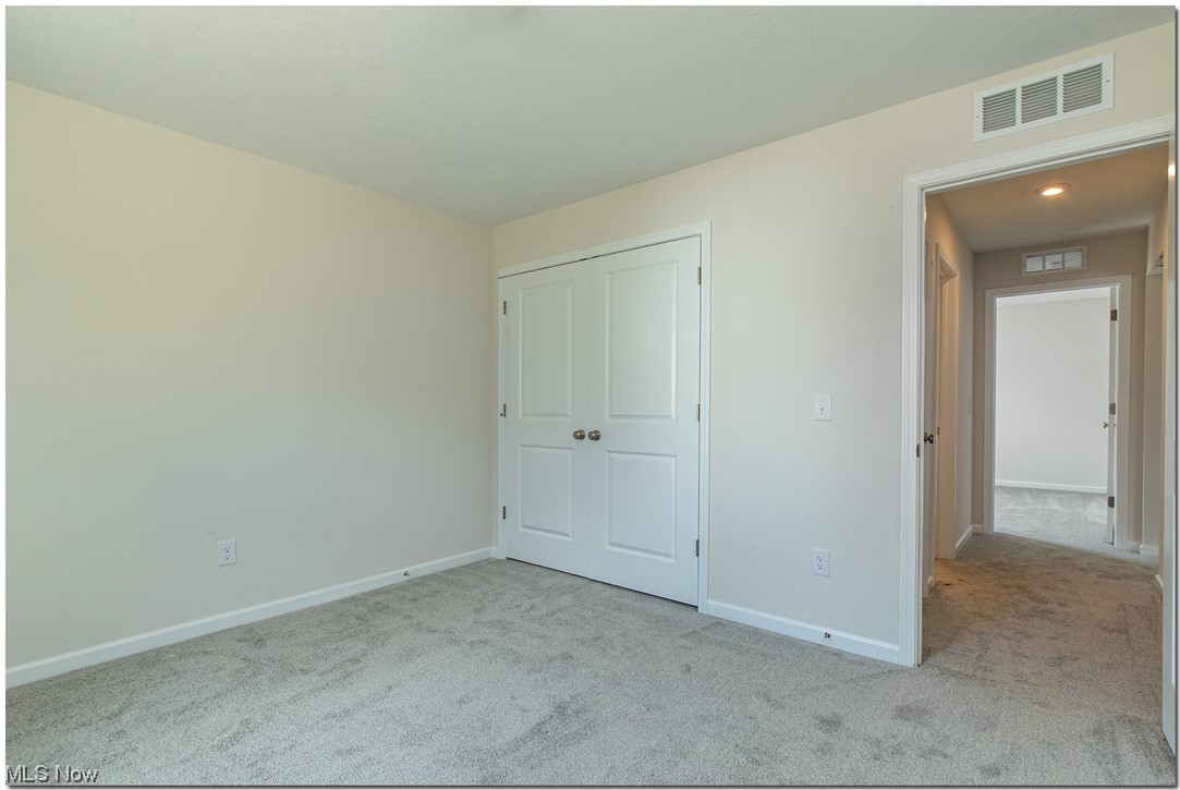 7701 Webster Road Middleburg Heights, OH 44130 - Photo 24 of 29 Unfurnished bedroom featuring light colored carpet and a closet
