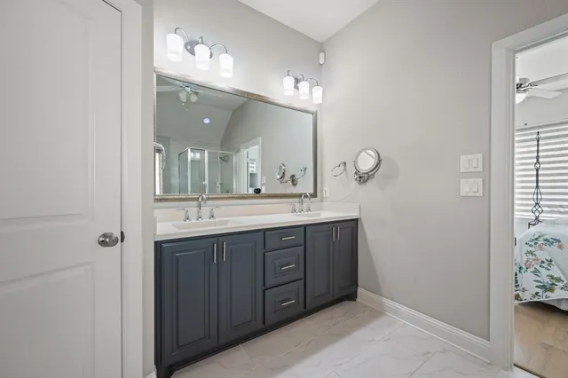 a bathroom with a double vanity sink and a mirror