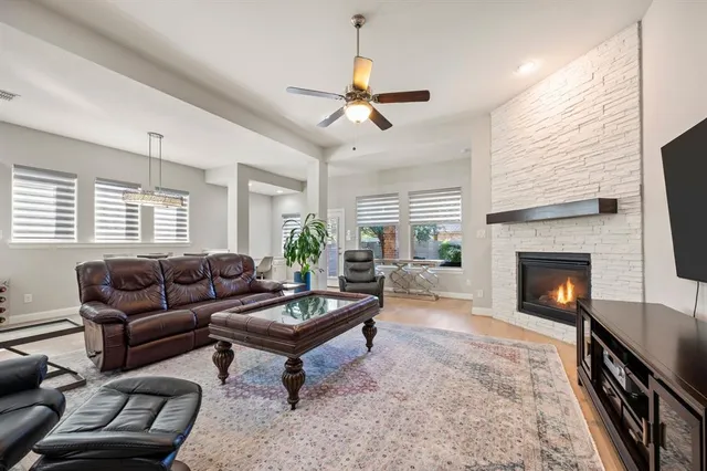 a living room with furniture a window and a fireplace