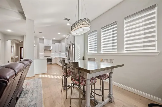 a view of a a dining room with furniture window and wooden floor