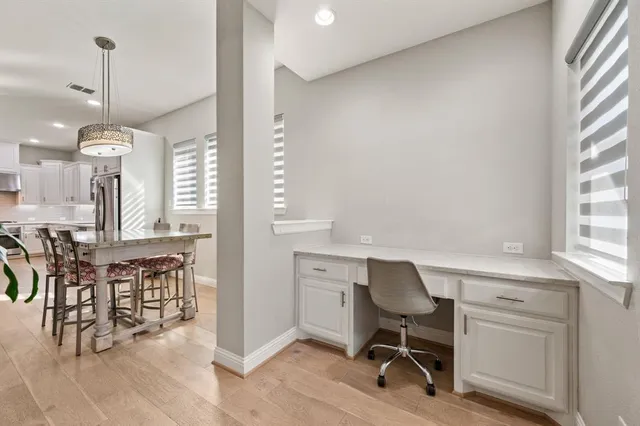 a view of a dining room with furniture and a chandelier