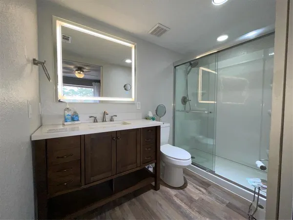 a bathroom with a sink toilet and shower