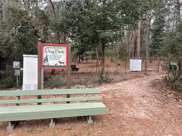 a view of a park with swings and a bench