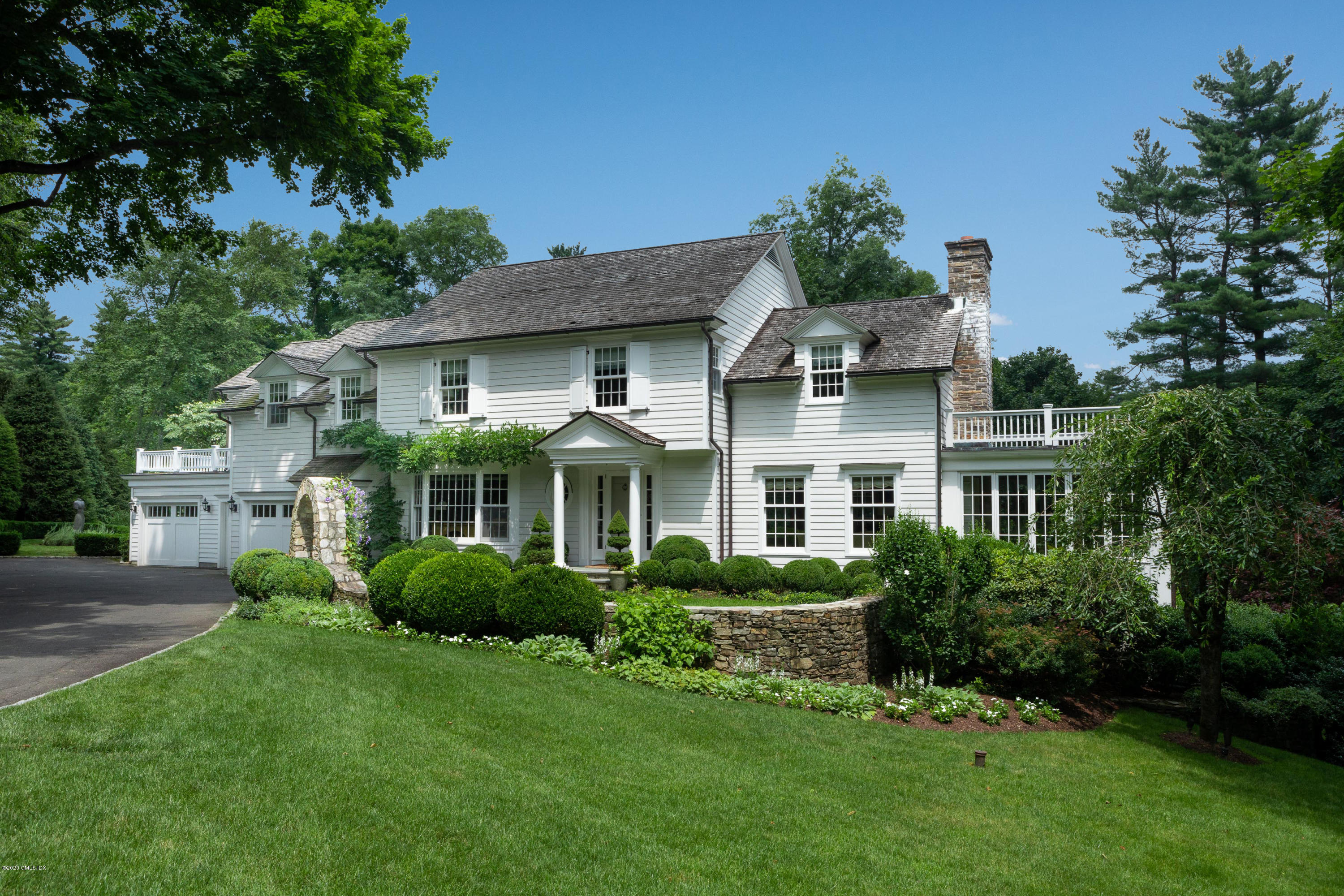 23 Boulder Brook Road Greenwich, CT 06830 - Photo 1 of 27 a front view of a house with a garden