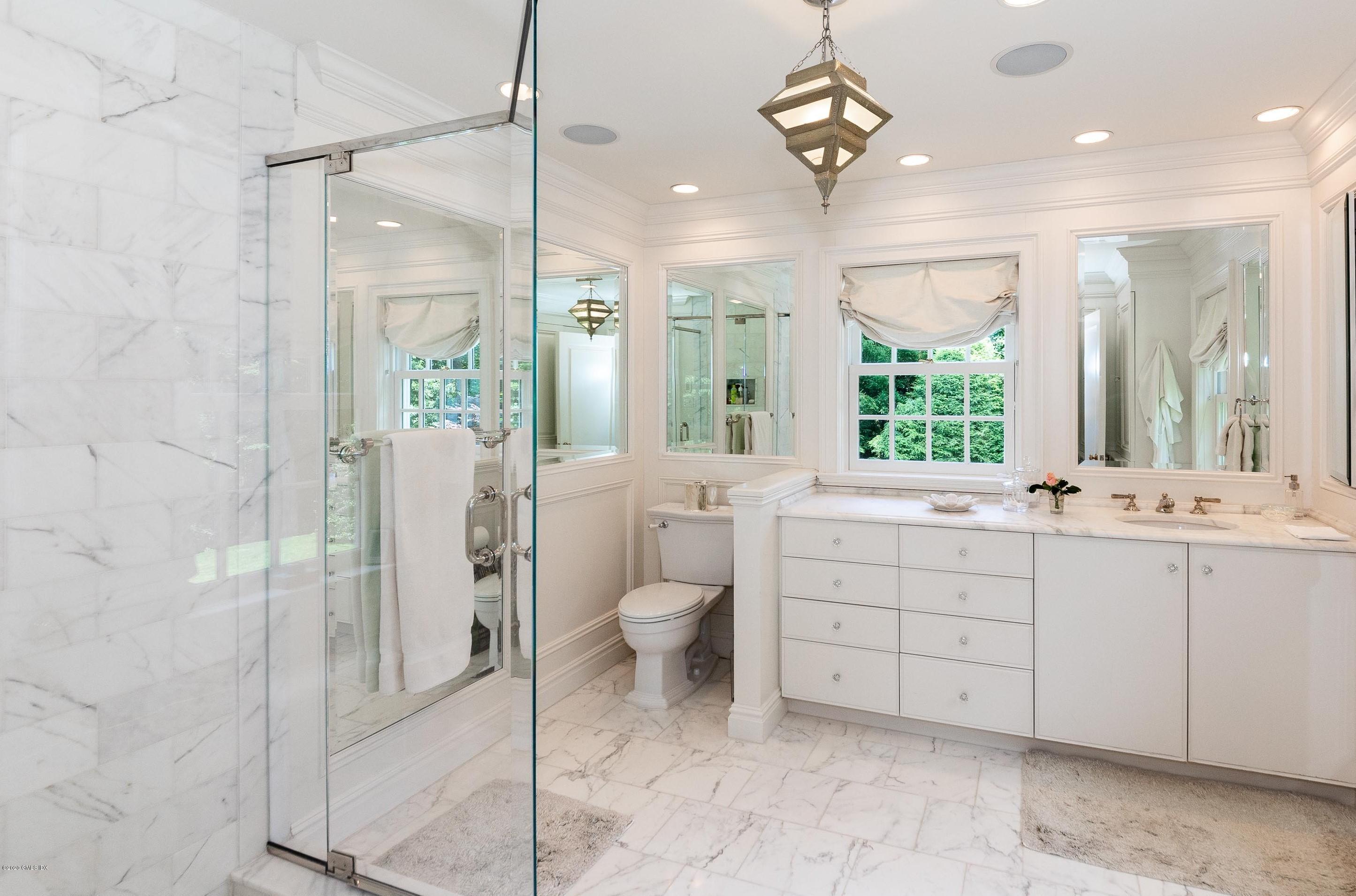23 Boulder Brook Road Greenwich, CT 06830 - Photo 12 of 27 a bathroom with a double vanity sink a toilet a mirror and shower