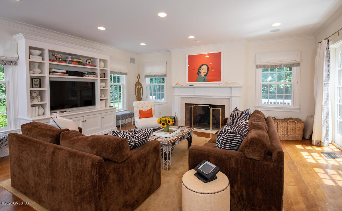 23 Boulder Brook Road Greenwich, CT 06830 - Photo 7 of 27 a living room with furniture a fireplace and a flat screen tv