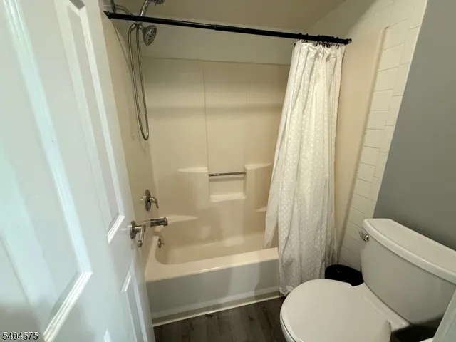 a bathroom with a shower and a toilet