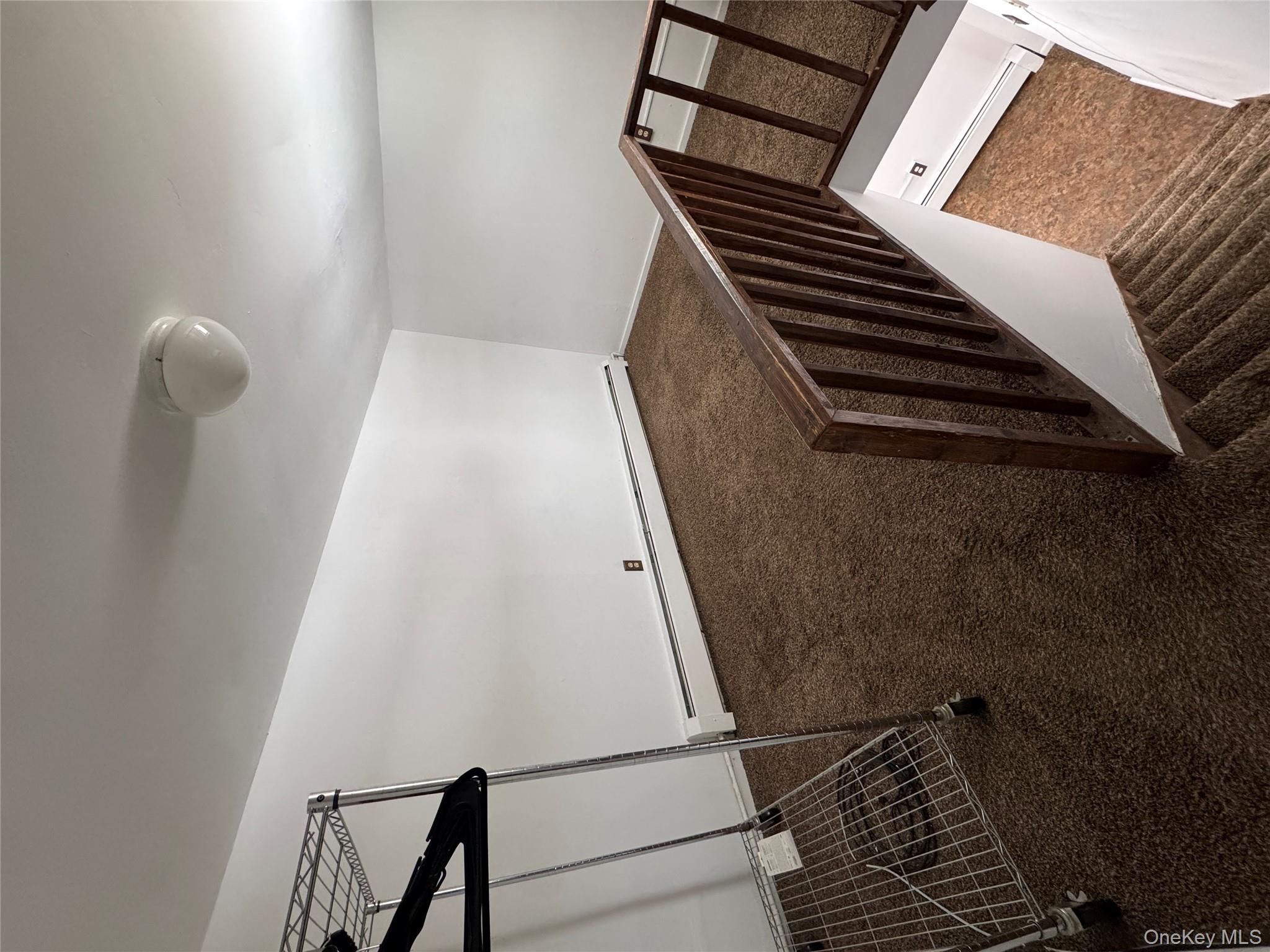 523 Fostertown Road Newburgh, NY 12550 - Photo 11 of 15 Staircase featuring carpet floors and a baseboard heating unit