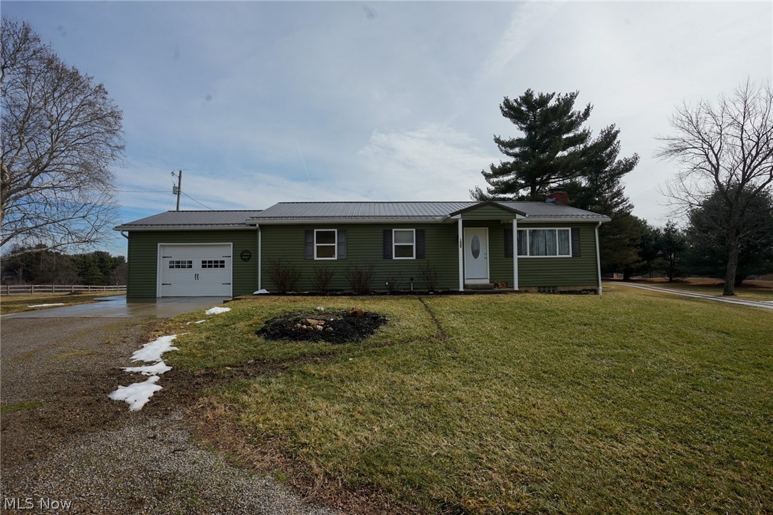 1325 County Line Road Hopewell, OH 43746 - Photo 1 of 45 Ranch-style house featuring driveway, a garage, a metal roof, a chimney, and a front yard