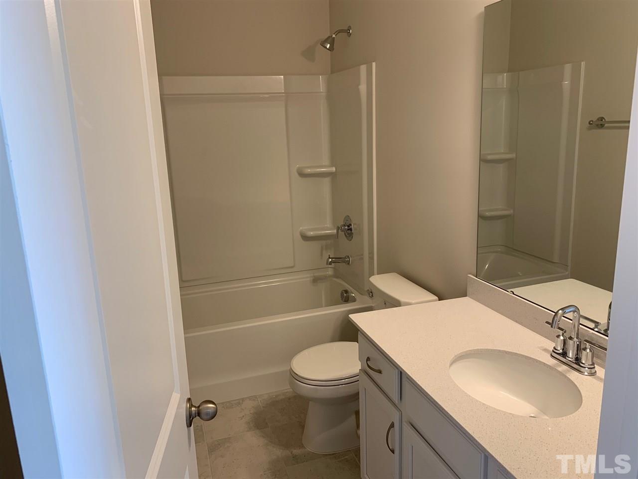 6108 Beale Loop, Unit 101 Raleigh, NC 27616 - Photo 20 of 30 a bathroom with a sink toilet and shower
