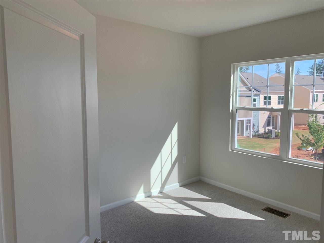 6108 Beale Loop, Unit 101 Raleigh, NC 27616 - Photo 23 of 30 a view of an empty room with a window