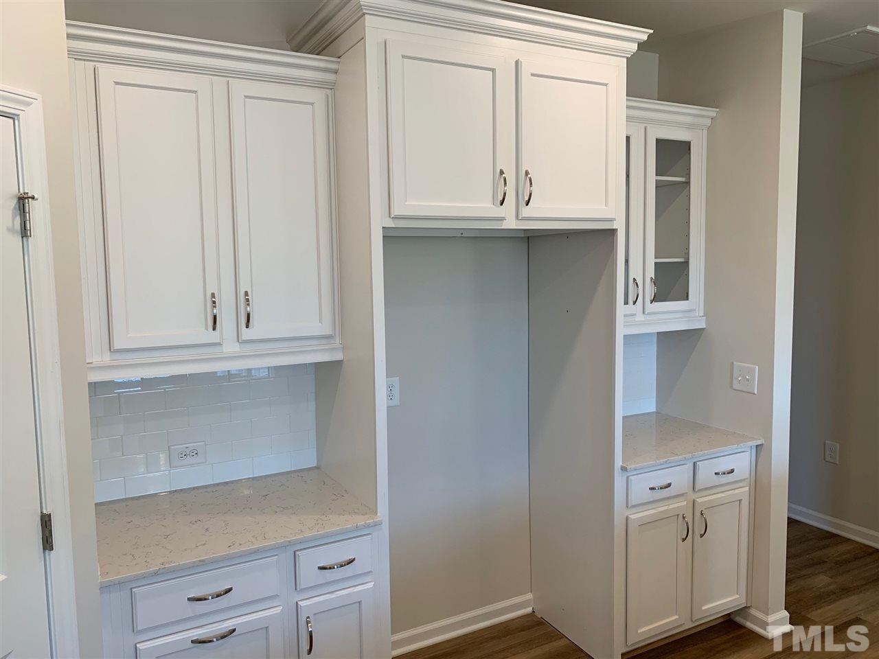 6108 Beale Loop, Unit 101 Raleigh, NC 27616 - Photo 5 of 30 a kitchen with white cabinets and a window