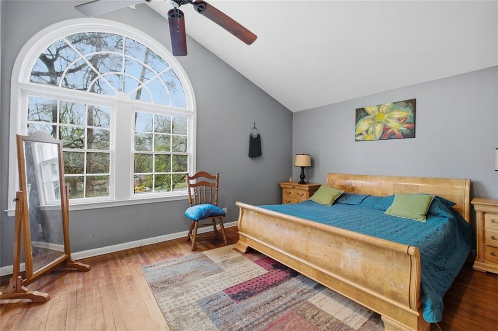 957 Rowland Road Stone Mountain, GA 30083 - Photo 24 of 36 a bedroom with a bed and wooden floor