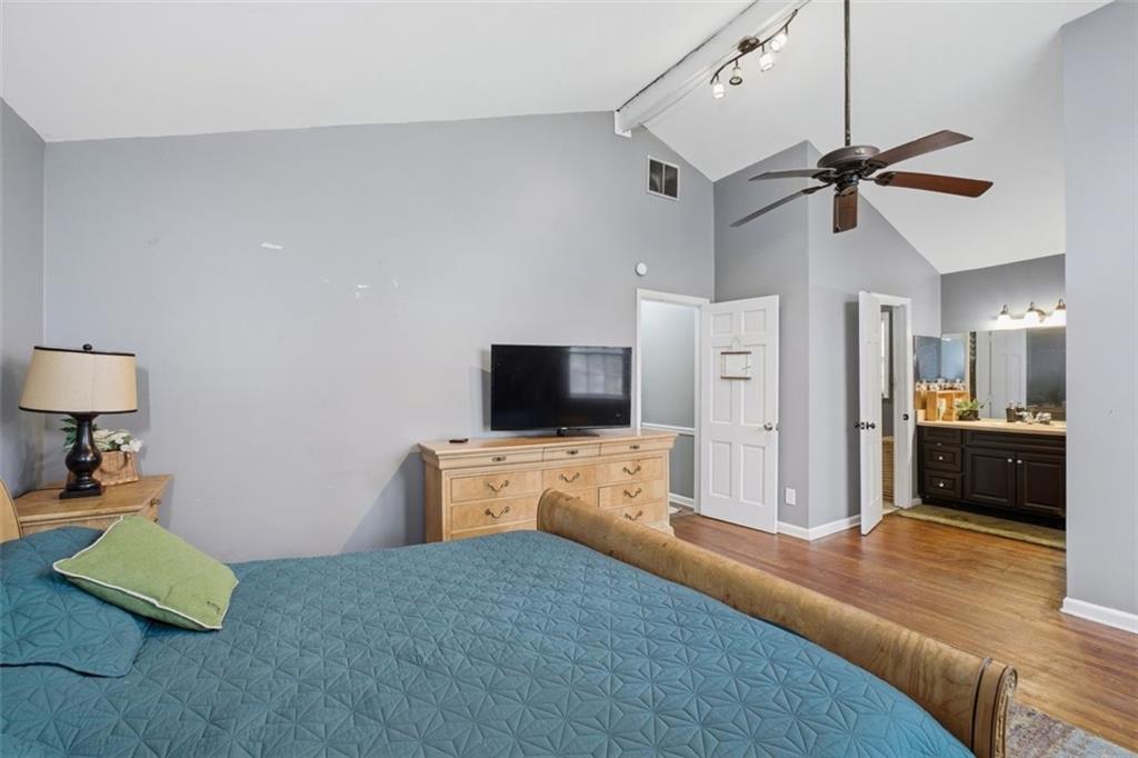 957 Rowland Road Stone Mountain, GA 30083 - Photo 25 of 36 a bedroom with a bed and a flat screen tv