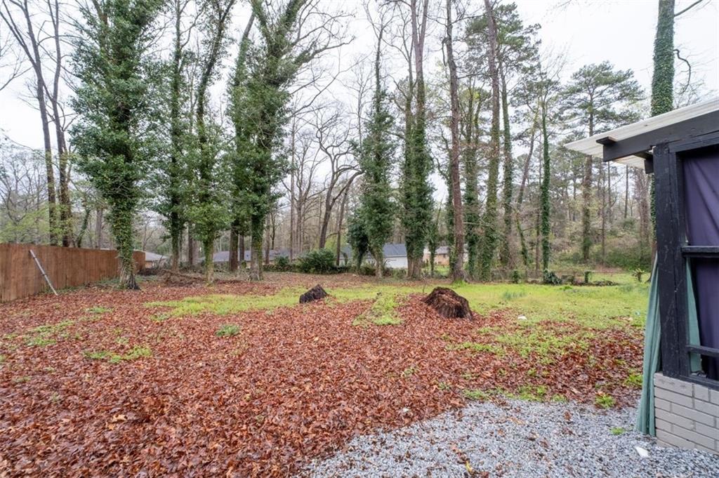 957 Rowland Road Stone Mountain, GA 30083 - Photo 35 of 36 a backyard of a house with a yard and outdoor seating