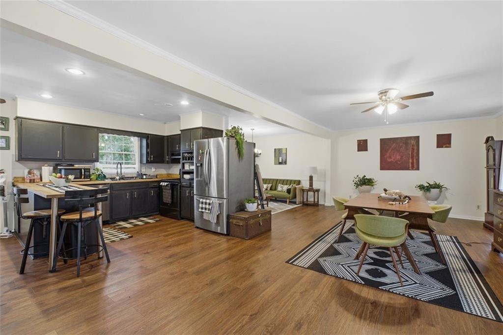 957 Rowland Road Stone Mountain, GA 30083 - Photo 5 of 36 a living room with furniture a wooden floor and kitchen view