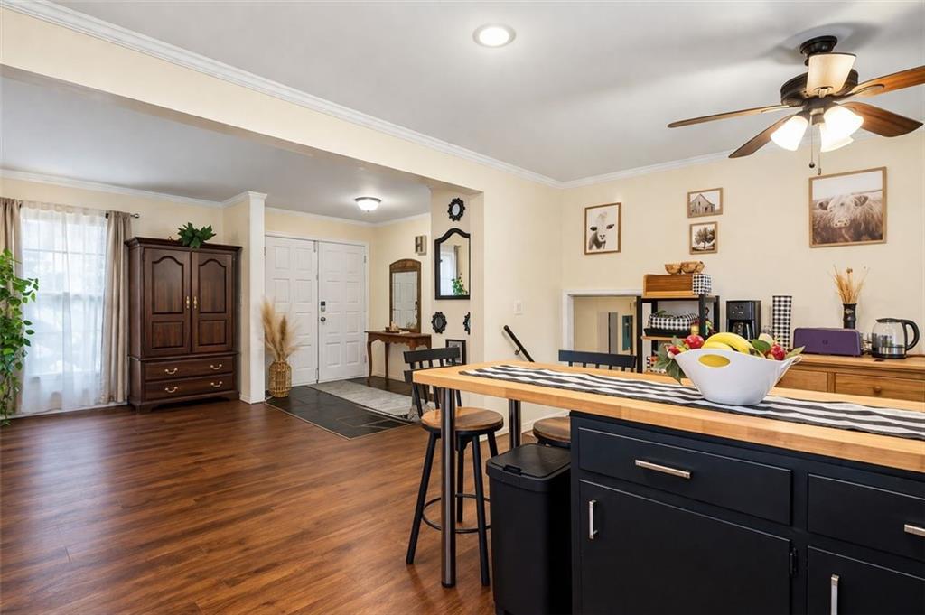 957 Rowland Road Stone Mountain, GA 30083 - Photo 8 of 36 a room with a table chairs and a refrigerator