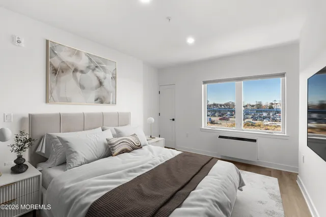 a bed room with a bed and a painting on the wall